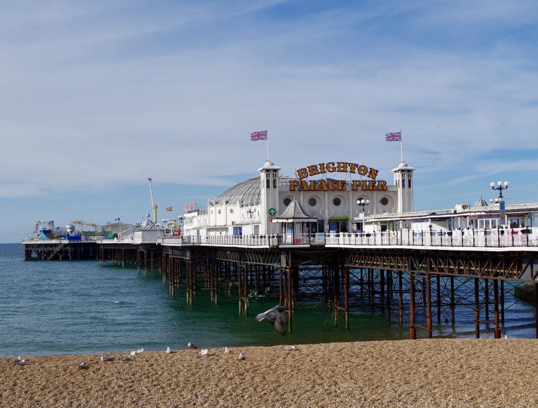 Views of the pier in Brighton on a sunny summers morning. The pier is shot from underneath for a different perspective. Brighton Palace Pier Opened in 1899 and home to fairground rides, bars, restaurants and deckchairs to enjoy the sea view.