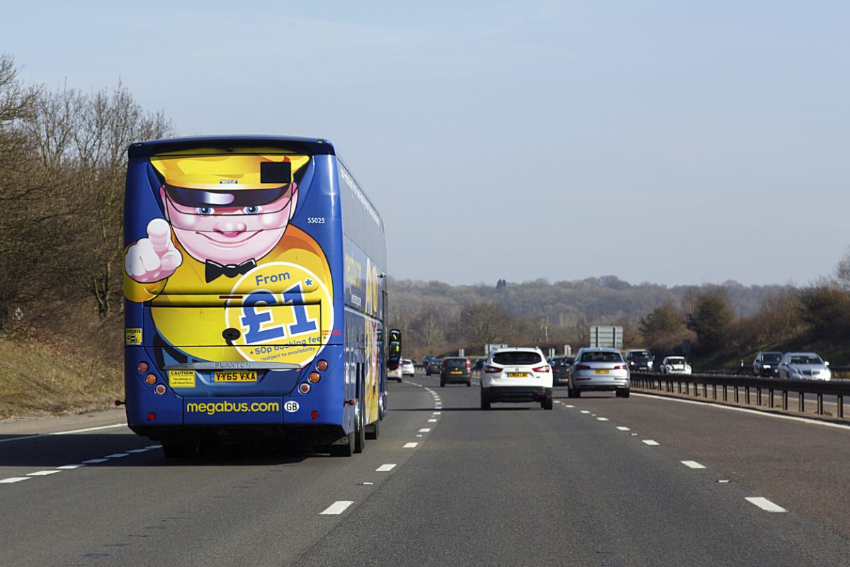 London, UK: February 24, 2018: A Megabus in transit on the M4. Megabus coach service travels to over 90 intercity destinations across the UK with cheap coach tickets from as little as £1.