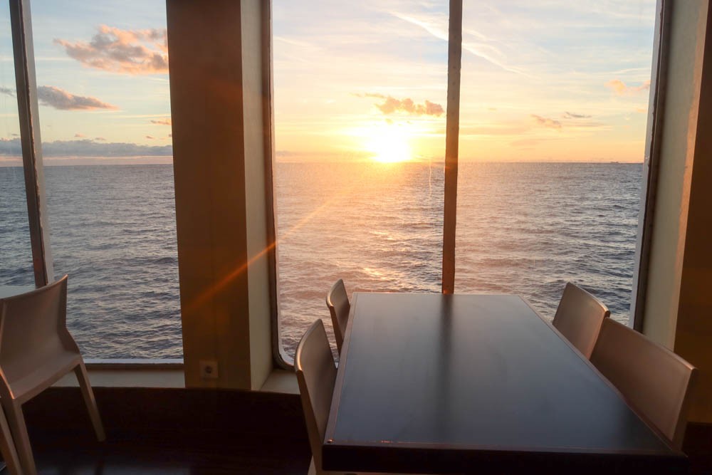 The restaurant in the Palma to Barcelona ferry with sunset out the window in background