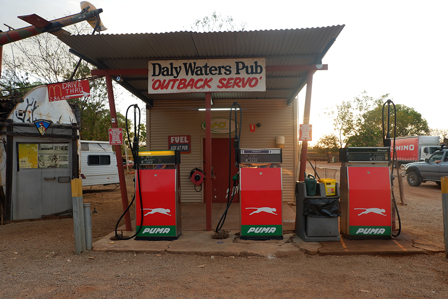 Outback service station at Daly Waters, with retro red pumps and signs above. 
