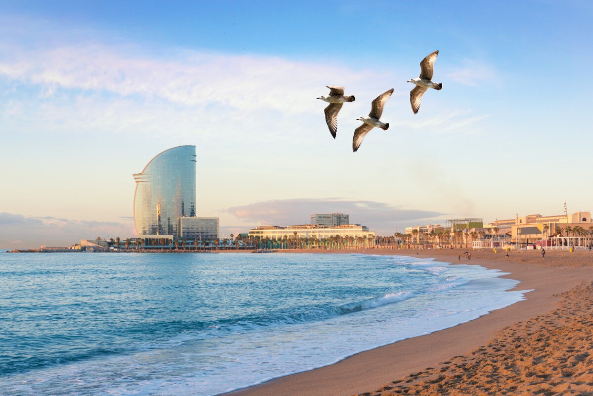 Barceloneta Beach in Barcelona with colorful sky at sunrise. Seafront, beach,coast in Spain. Suburb of Barcelona, Catalonia