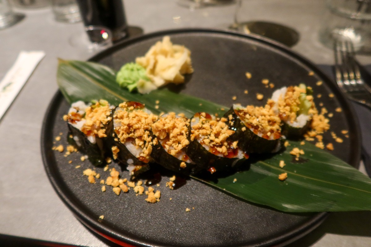 Vegetarian sushi on a dark grey plate on a table at Fish Me