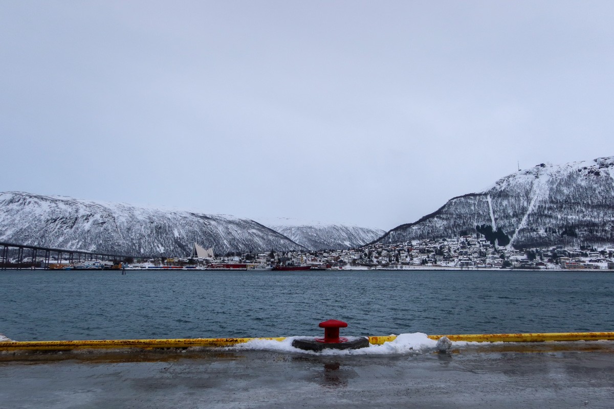 View looking over the harbour from Tromso. The Arctic Cathedral is in the skyline over the water.