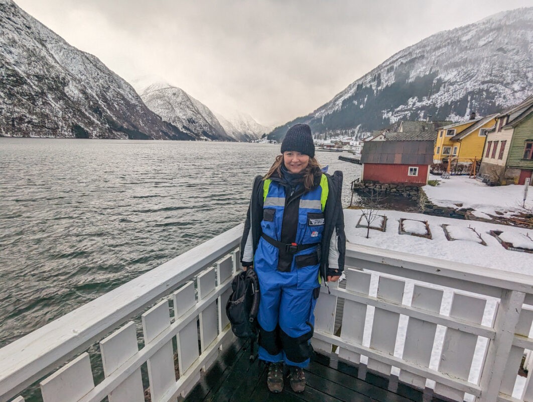 Things to do in Fjaerland. Claire stands with an epic fjord backdrop