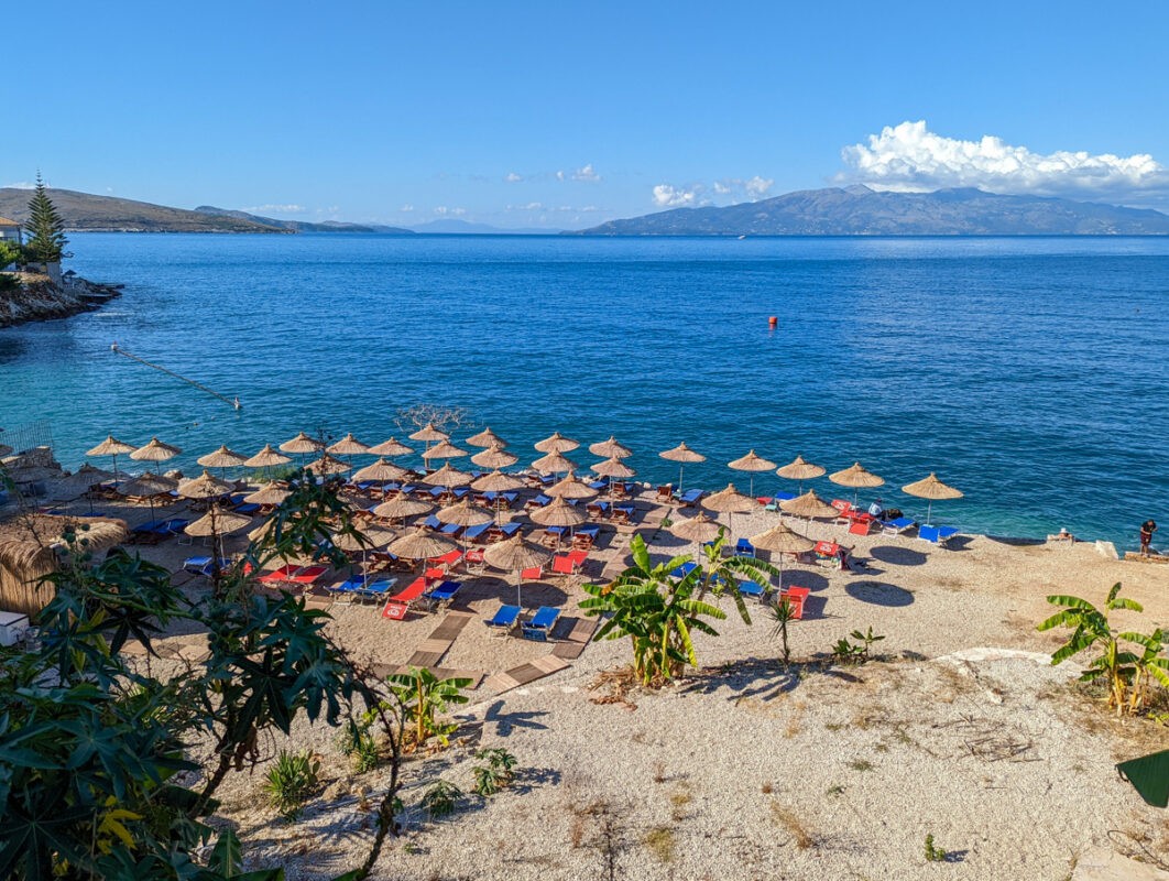 Almost deserted beach, with deckchairs and parasols lined up along the sands, in Albania
