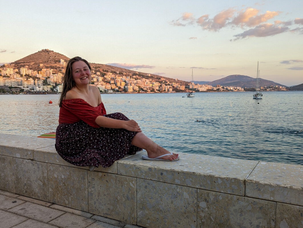 Claire in Albania with the sunset in the background