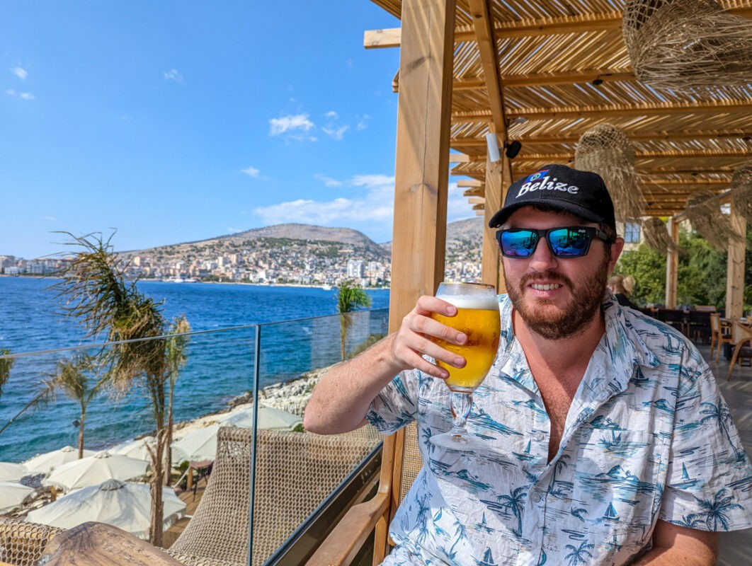 Man drinking beer at a beach bar in Albania
