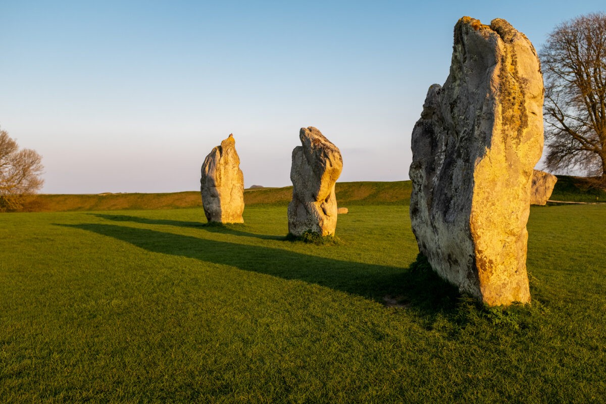Prehistoric standing rocks at a golden sunset in a field in Wiltshire, United Kingdom, nobody in the image