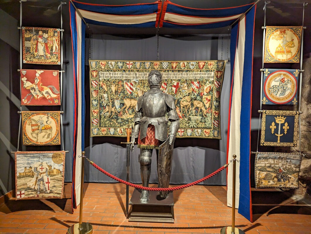 Inside the house of the Black Heads in Riga. There's an armour and tapestries.