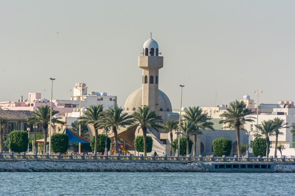 A common small mosque with palm tree in the Dammam Corniche coastal park in Dammam, Kingdom of Saudi Arabia